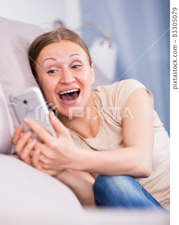 Happy woman using smartphone Happy woman using smartphone 83305079