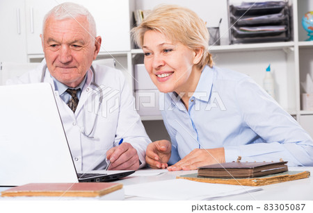 Male doctor with female client Male doctor with female client 83305087