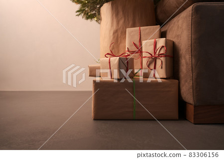 gift boxes under christmas tree with warm light 83306156