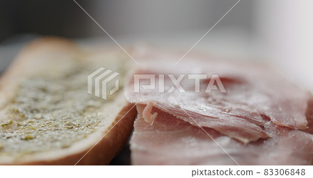 prosciutto slices on baguette to make sandwich 83306848
