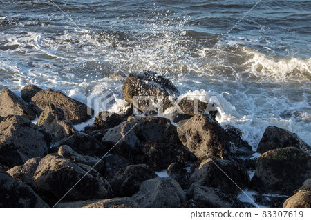 Incoming Ocean Waves Breaking Over Coastal Rocks Incoming Ocean Waves Breaking Over Coastal Rocks 83307619