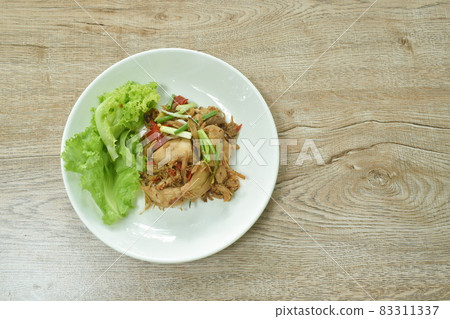 spicy fried roasted chicken meat with chili dressing slice spring onion with lettuce on plate spicy fried roasted chicken meat with chili dressing slice spring onion with lettuce on plate 83311337