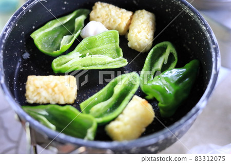 Peppers fried in a frying pan Peppers fried in a frying pan 83312075