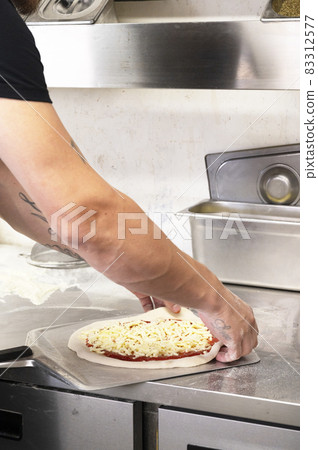 London, U.K., July 22,2021- man or chef cooking and selling pizza in Covent Garden in London. Street food. 83312577