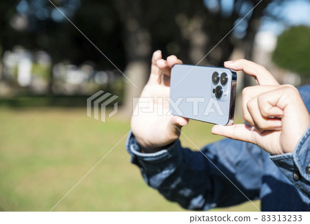 Men's hands shooting with a smartphone Men's hands shooting with a smartphone 83313233