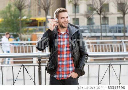 I like music. Happy man listen to music urban outdoor 83313598