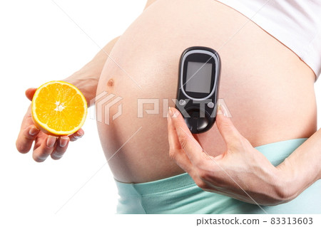 Pregnant woman with glucometer and orange, diabetes and healthy nutrition during pregnancy Pregnant woman with glucometer and orange, diabetes and healthy nutrition during pregnancy 83313603