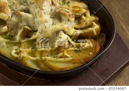 Close view of dish of baked meat with potatoes in low pot Close view of dish of baked meat with potatoes in low pot 83314067