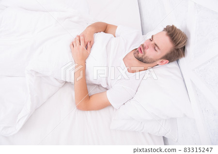 man sleep in bed. early morning wakeup. man sleeping man sleep in bed. early morning wakeup. man sleeping 83315247