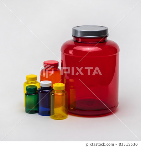 Multi colored transparent plastic pill jars on a white background. Isolated 83315530