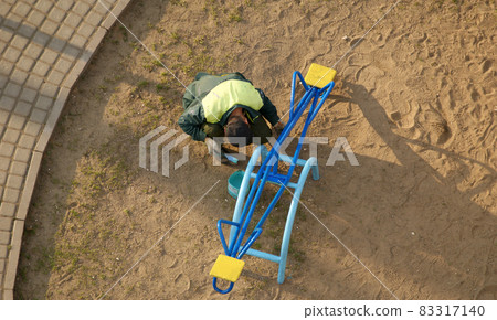 workers paint multicolored paint a public playground, Moscow, Russia 83317140