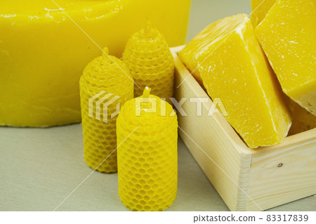 large pieces of natural beeswax, close-up, raw materials for candles. 83317839