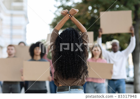 Unrecognizable long-haired woman leading group of protestors Unrecognizable long-haired woman leading group of protestors 83317948