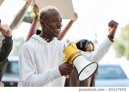 Closeup of cheerful african american guy leading students strike 83317958