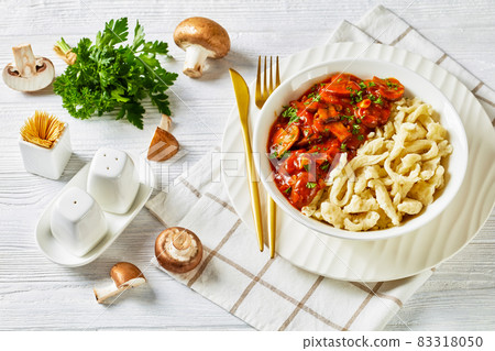 spaetzle with mushroom gravy in a white bowl spaetzle with mushroom gravy in a white bowl 83318050