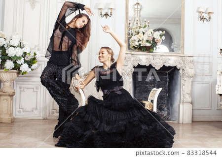 two young pretty lady in black lace fashion style dress posing in rich interior of royal hotel room, luxury lifestyle people concept 83318544