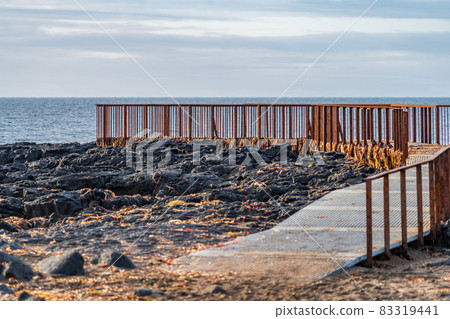Rusty viewpoint to the ocean over the lava fields 83319441