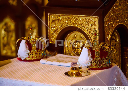 Traditional wedding crowns in a church. Wedding crown in church ready for marriage ceremony Traditional wedding crowns in a church. Wedding crown in church ready for marriage ceremony 83320344