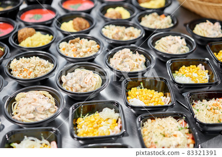 Food delivery. Different in plastic disposable lunch box with healthy natural food. Chicken broth, mashed soup, mashed potatoes with cutlet, seafood pasta, salads, pilaf with a fresh bun. 83321391