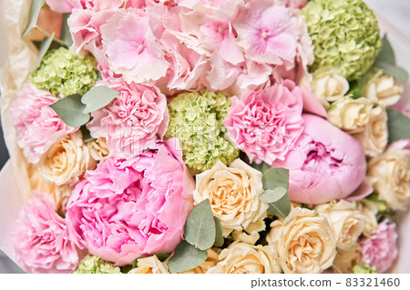 closeup Pink peonies and hydrangea. Beautiful bouquet of mixed flowers in woman hand. Floral shop concept . Handsome fresh bouquet. Flowers delivery. 83321460