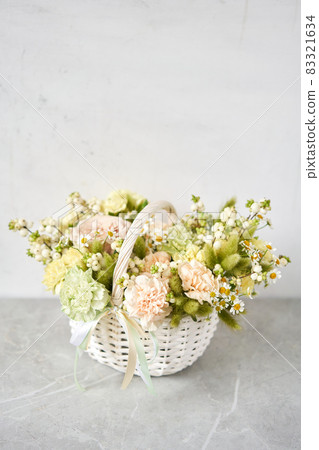Flower arrangement in Wicker basket. Beautiful bouquet of mixed flowers. Handsome fresh bouquet. Small flower shop and Flowers delivery. 83321634
