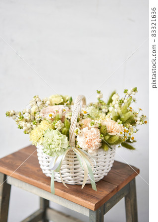 Flower arrangement in Wicker basket. Beautiful bouquet of mixed flowers. Handsome fresh bouquet. Small flower shop and Flowers delivery. 83321636