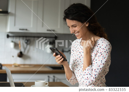 Happy overjoyed woman with smartphone getting unbelievable good news Happy overjoyed woman with smartphone getting unbelievable good news 83322335