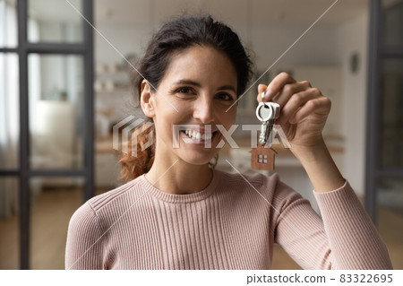 Portrait of smiling woman renter show house keys Portrait of smiling woman renter show house keys 83322695