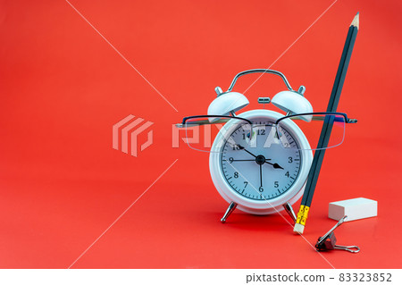 Concept Education or business Alarm clock and teacher glasses Business objects isolated on colorful background Back to school concept 83323852