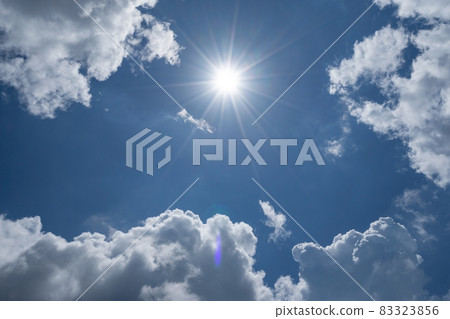 Shining sun on clear blue sky with lens flare of sunlight on sky background Bright sun on blue sky white clouds Nature and environment background Shining sun on clear blue sky with lens flare of sunlight on sky background Bright sun on blue sky white clouds Nature and environment background 83323856