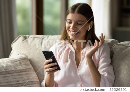 Happy girl with wireless earphone listening to radio music Happy girl with wireless earphone listening to radio music 83326291