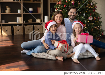 Portrait of happy family celebrating New Year holidays. 83326499