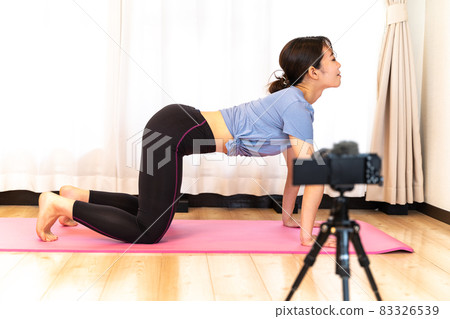 A woman delivering yoga videos at home A woman delivering yoga videos at home 83326539