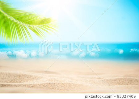 Blur beautiful nature green palm leaf on tropical beach with bokeh sun light wave abstract background. 83327409