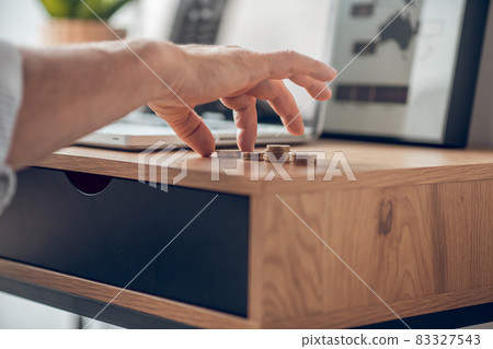 Close up picture of a man calculating coins on the table 83327543