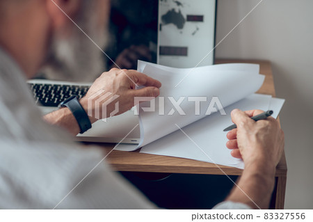 Close up picture of a man signing the documents Close up picture of a man signing the documents 83327556