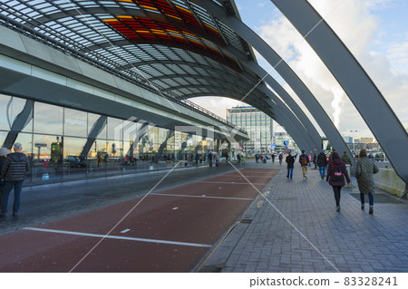Amsterdam, Netherlands - Nov 30, 2019 : Passengers taking bus at the bus terminal station in the Amsterdam Centraal in Amsterdam, Netherlands on Nov 30, 2019. Amsterdam, Netherlands - Nov 30, 2019 : Passengers taking bus at the bus terminal station in the Amsterdam Centraal in Amsterdam, Netherlands on Nov 30, 2019. 83328241