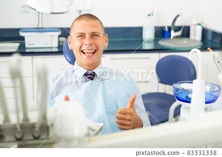 Portrait of a positive man patient sitting in a dental chair Portrait of a positive man patient sitting in a dental chair 83331338