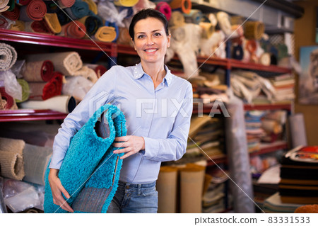 Adult woman buyer choosing colour carpets 83331533