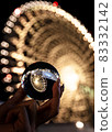 Hand holding a lens ball 83332142