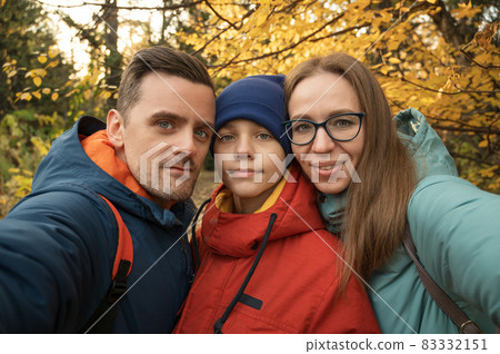 Happy family selfie in autumn park 83332151