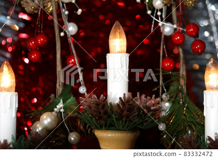New Year's electric candles on the background of Christmas decorations New Year's electric candles on the background of Christmas decorations 83332472