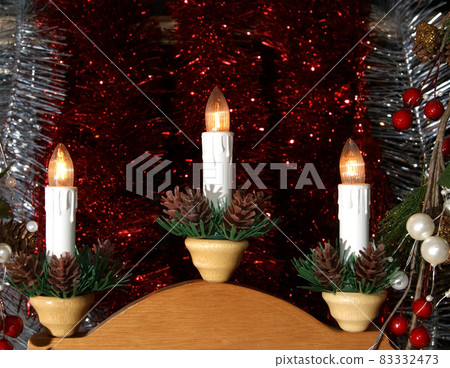 New Year's electric candles on the background of Christmas decorations 83332473