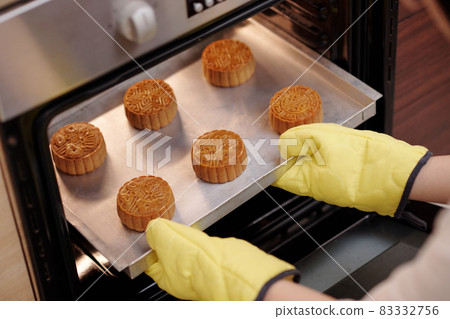 Taking Mooncakes out of Oven 83332756
