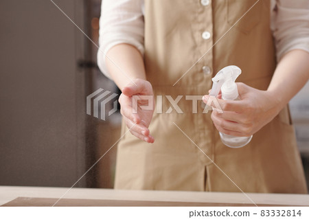 Woman Spraying Water on Hands 83332814