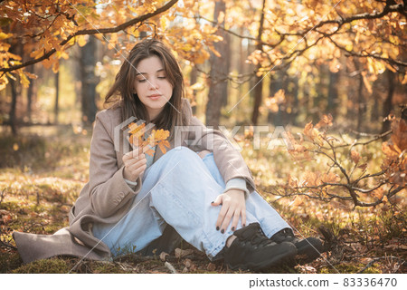 Young teenager girl in the autumn forest Young teenager girl in the autumn forest 83336470
