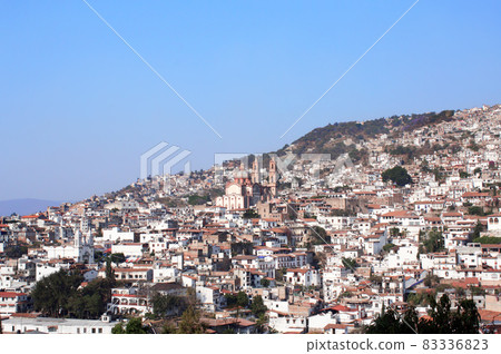 View on Taxco de Alarcon city and Santa Prisca Parish Church, Mexico 83336823