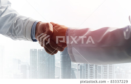 Close-up of the handshake between the two medics 83337229