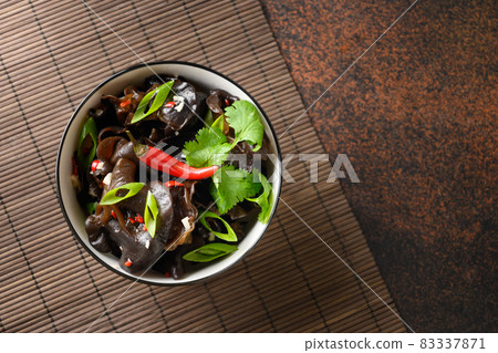 Salad of chinese pickled tree black muer mushrooms in bowl on white background. 83337871