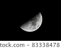 Half moon floating in the dark night sky (first quarter moon) 83338478